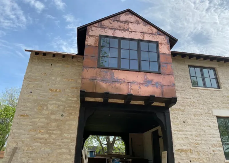 Copper metal panel facade on a stone building for Skylight Installation in Mililani Mauka